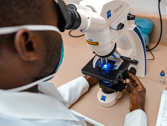 A Pathologist is conducting a Histopathology Biopsy Test in a lab.