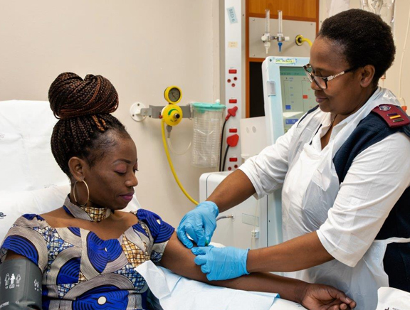 A doctor is assisting a female patient for Dialysis Treatment.