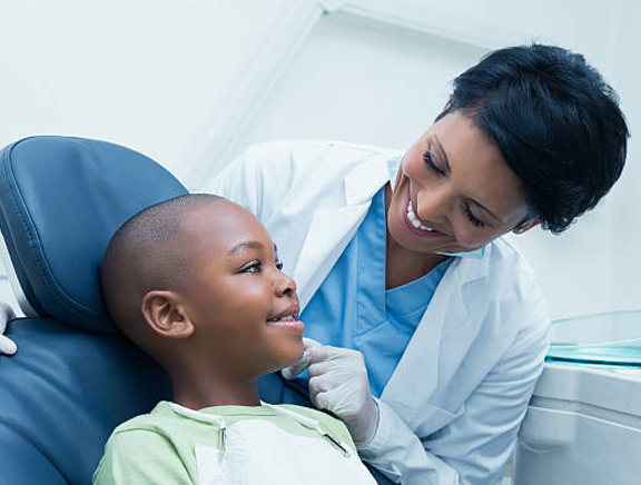 A dentist examining a child's teeth.