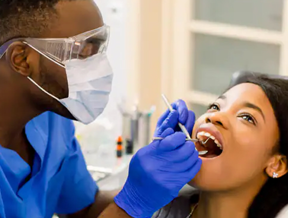 Life Care dentist examining patient's teeth.
