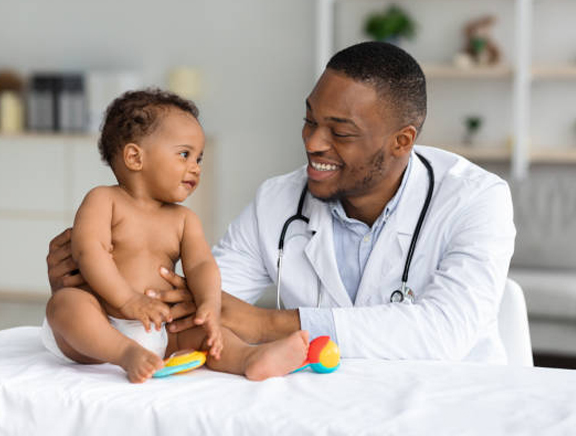 A Paediatrician examining a baby.